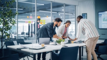 Diverse Team of Professional Businesspeople Meeting in the Office Conference Room. Creative Team Around Table, Black Businesswoman, African-American Digital Entrepreneur and Hispanic CEO Talking.