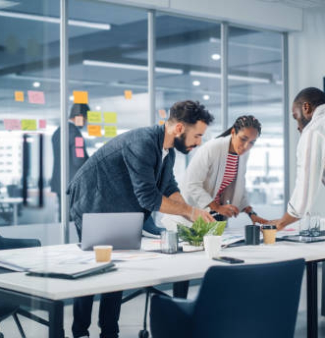 Diverse Team of Professional Businesspeople Meeting in the Office Conference Room. Creative Team Around Table, Black Businesswoman, African-American Digital Entrepreneur and Hispanic CEO Talking.